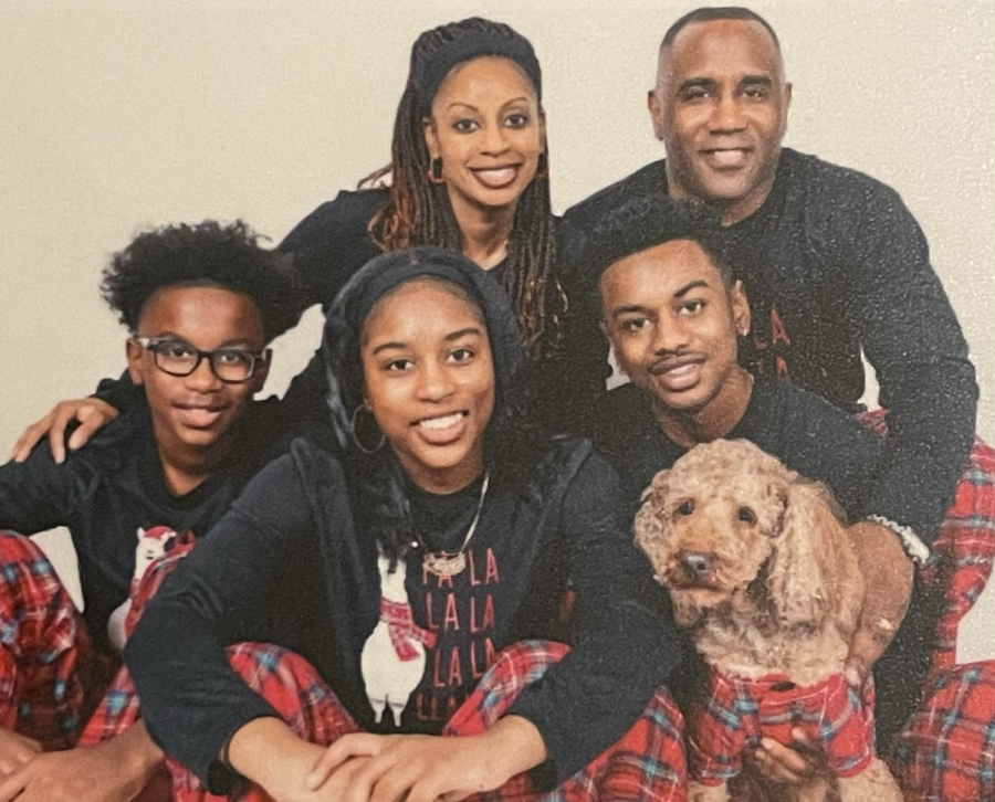 Junior Brianna Ottey (center) with brothers Brent (left) and Brandon, parents Yori and Eustace and pup Milo in matching flannel