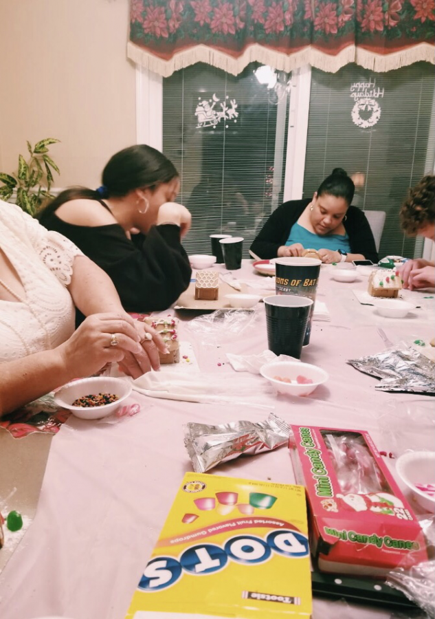 Senior Abigail Rodriguez makes gingerbread cookies with family members Lisandra and Daniel Simpkins