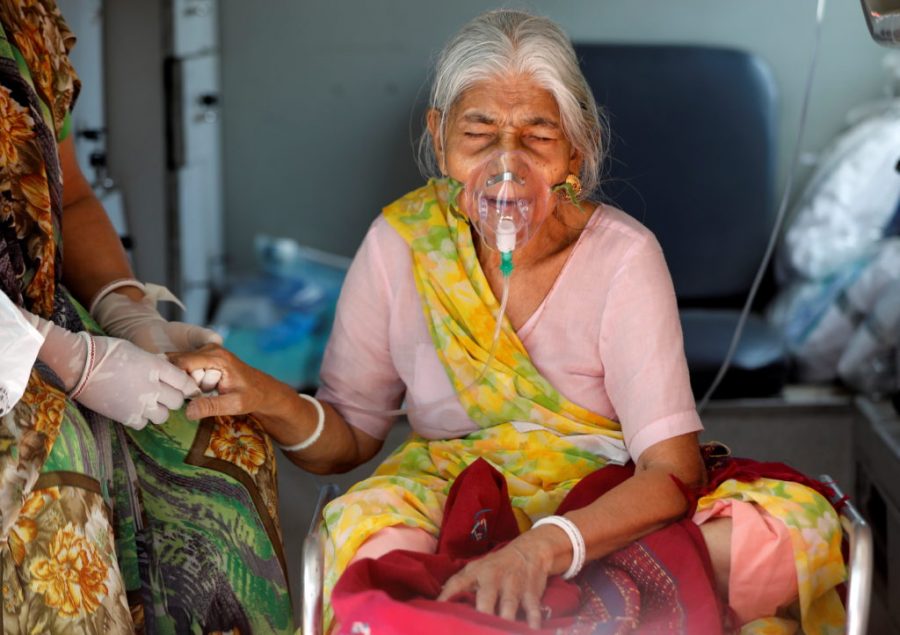 Lilaben Gautambhai Modi, 80, wearing an oxygen mask, sits inside an ambulance as she waits to enter a COVID-19 hospital for treatment, amidst the spread of the coronavirus disease (COVID-19), in Ahmedabad, India, May 5, 2021. REUTERS/Amit Dave