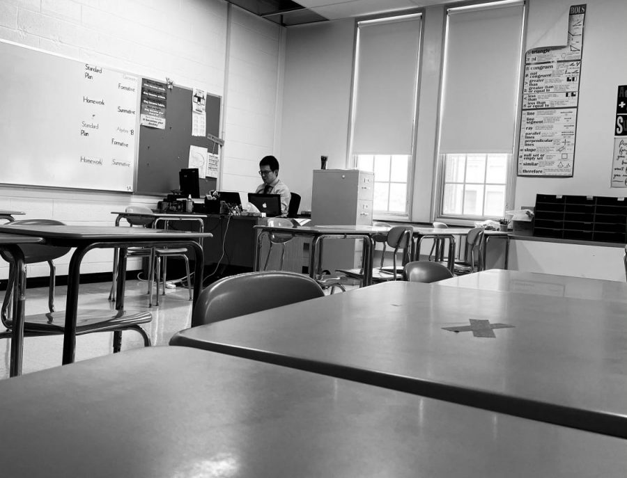 Math teacher Mr. Wang works late in his classroom long after his students have left for the day.