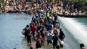 Migrants crossing a dam in Texas in September