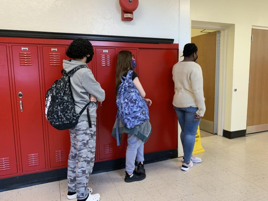 Students wait in line for a bathroom to open at the beginning of class