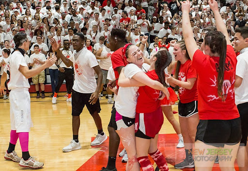 Members of the Red and White teams hugging during the event