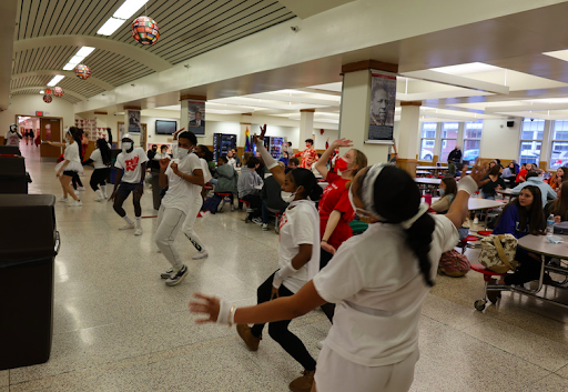 RAWN relaunch team members dancing in the cafeteria during the flash mob