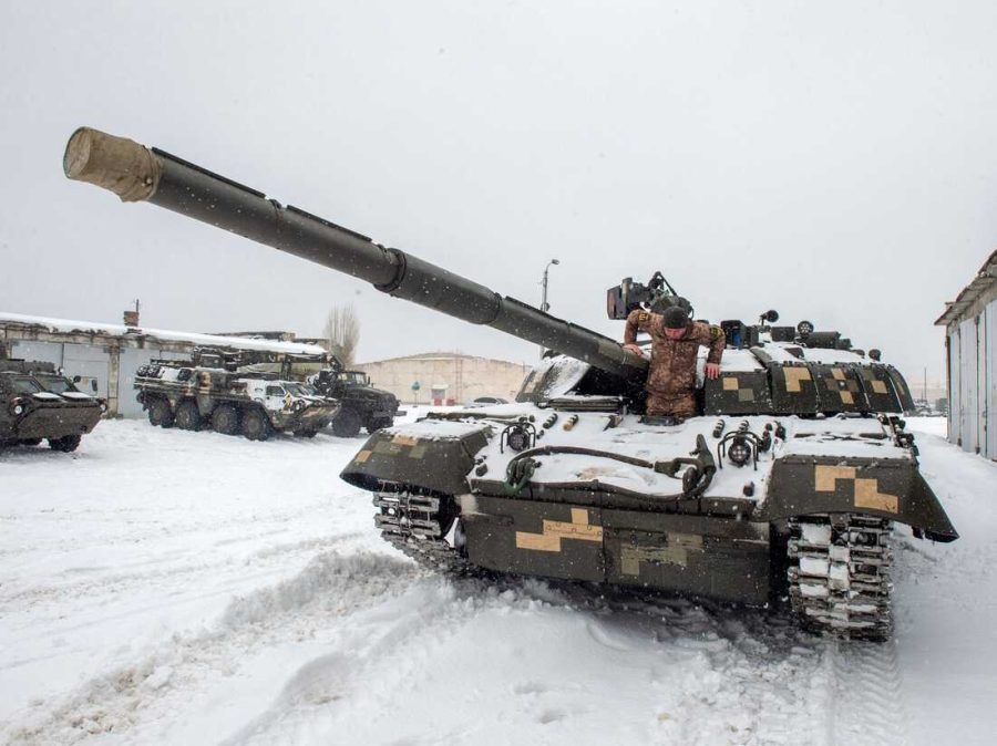 An Ukrainian Military Forces serviceman exits from a tank on the Ukrainian border with Russia