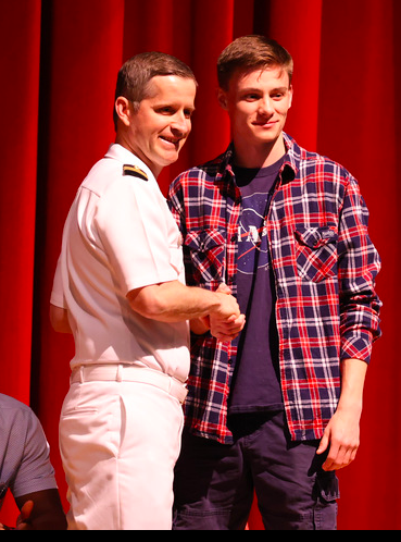 Steven Wiser shaking hands with Commander Sean Easley at the Armed Services Recognition Program 