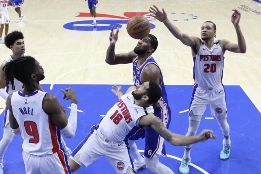 Joel Embiid fights for a rebound against the Pistons on January 10