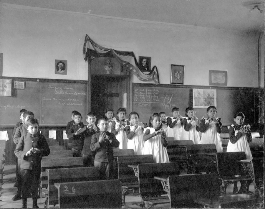 Young American Indian children learn to sing a song at the Carlisle Indian Industrial School