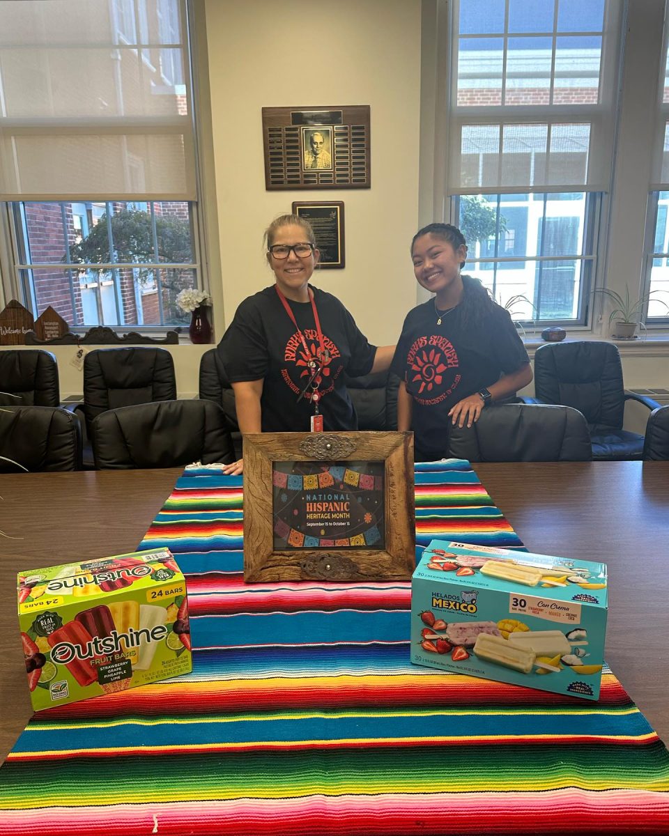 Mrs. Ochoa and senior Bea Faigal serve RV teachers a special treat, fruit paletas, to kick off Hispanic Heritage Month.