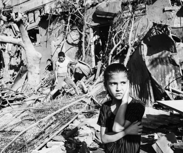 A child outside rubble on October 31