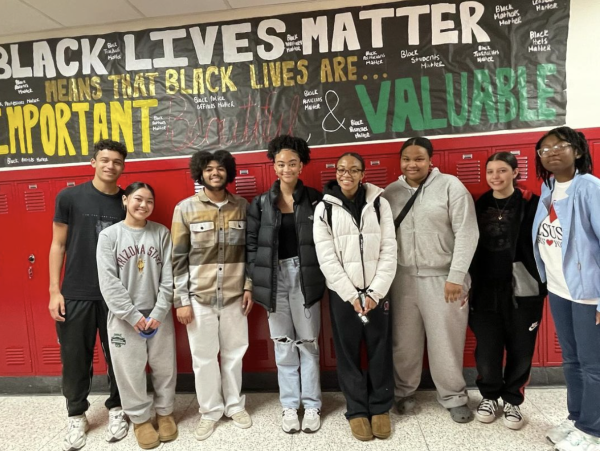 Members of the Black Student Union display their annual banner in the C-wing