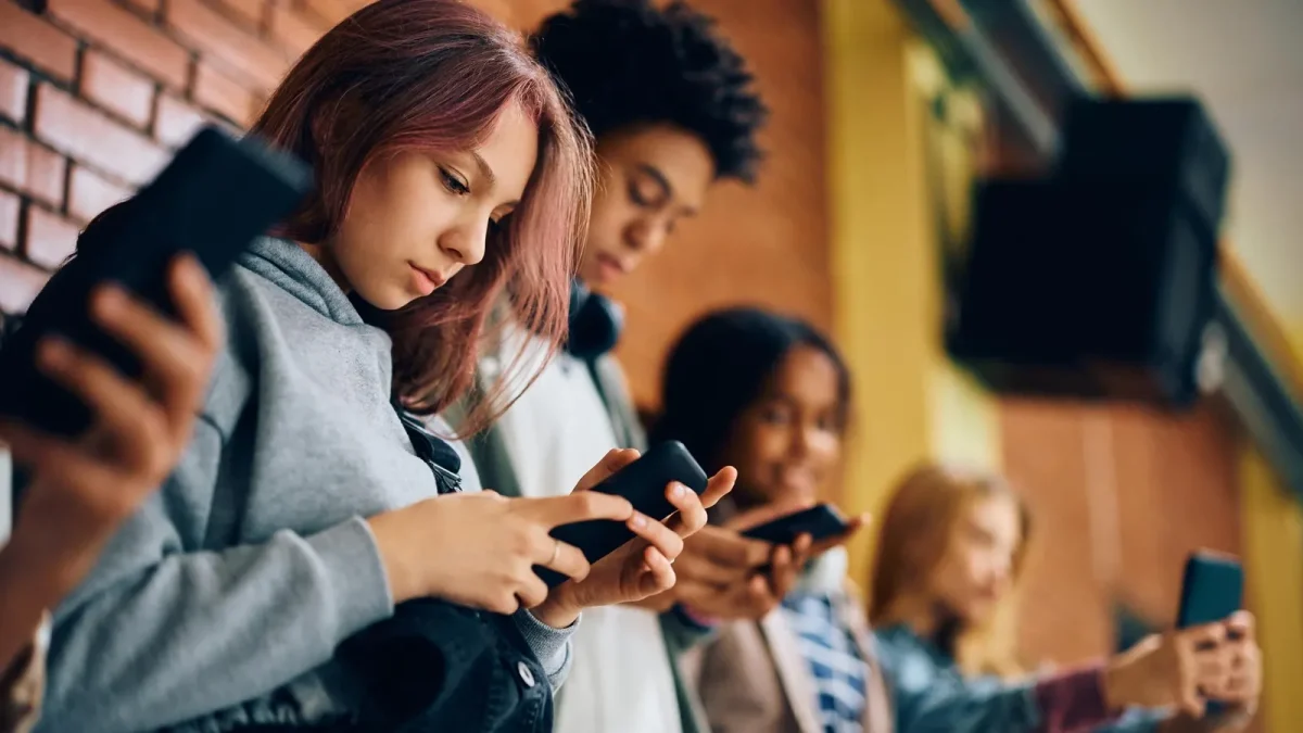 High School students hooked on their phones after school. 