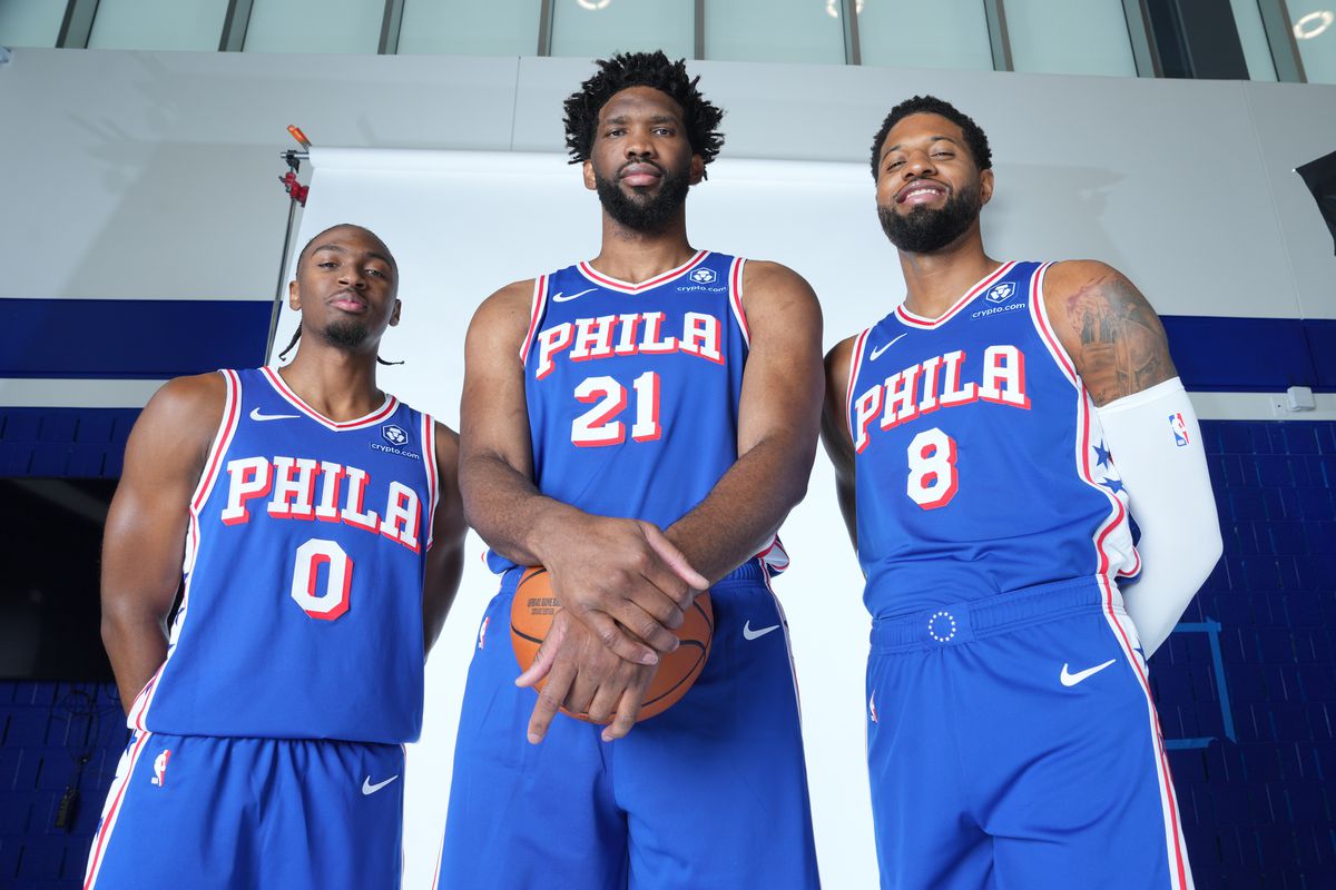 Philadelphia's Tyrese Maxey (left), Joel Embiid (middle), and Paul George (right) pose for picture at 2024 Media Day