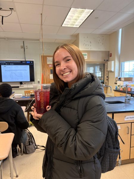 Senior Tina Brandecker holds her Dunkin' order on a snowy day.