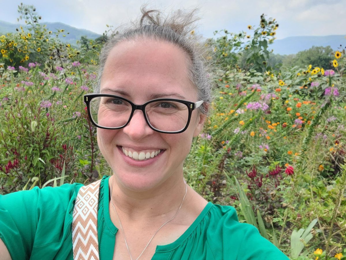 Ms. Sandman admires the scenery, taking a picture at the Jones Farm in Cornwall, New York.